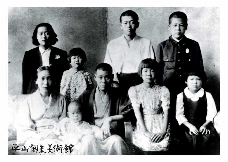 A ceremonial photograph with his family when he was the second grade at a junior high school The back row right-side end (1944)